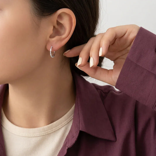 Circular 18K gold earrings by Ghamieh, showcasing a sleek and elegant design.